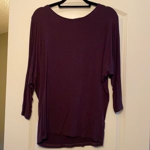 Will be donated 10/01. 
NEVER WORN. Dolman sleeve top with zebra detail on back.